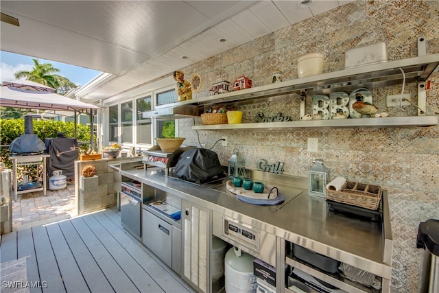 deck featuring exterior kitchen and area for grilling