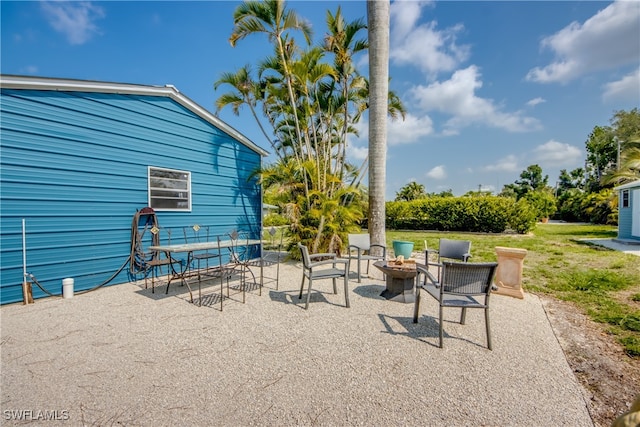 view of patio with an outdoor fire pit