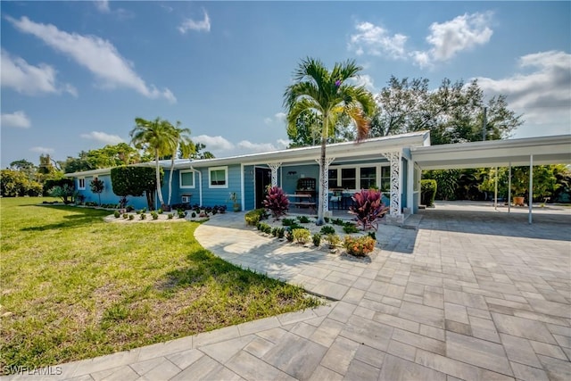 1862 Linhart Ave, Fort Myers, FL 33901 - view of front of house with an attached carport, decorative driveway, and a front yard