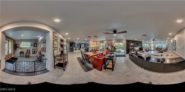 living room featuring ceiling fan and a healthy amount of sunlight