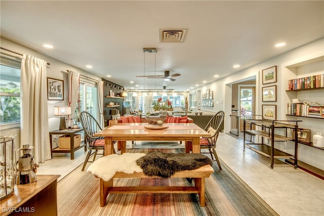 dining area featuring a healthy amount of sunlight, light tile patterned floors, and ceiling fan