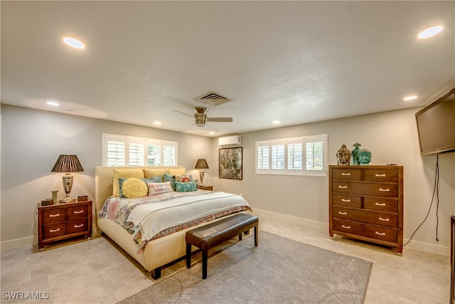 bedroom with multiple windows, ceiling fan, and a wall unit AC