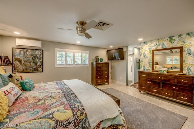 bedroom with ceiling fan and a wall unit AC