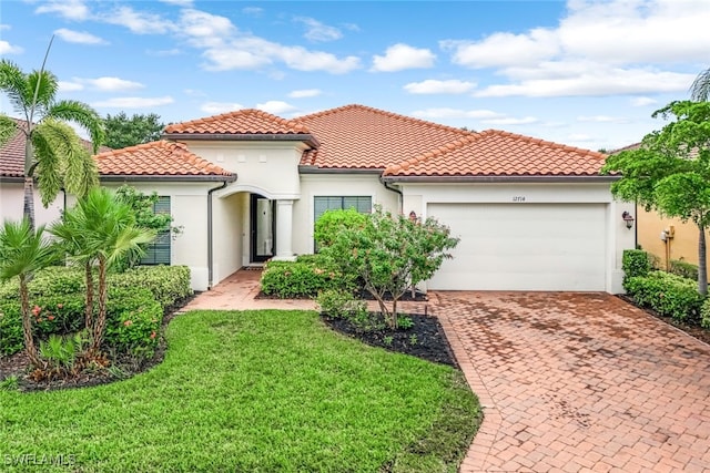 mediterranean / spanish-style home with a garage and a front lawn