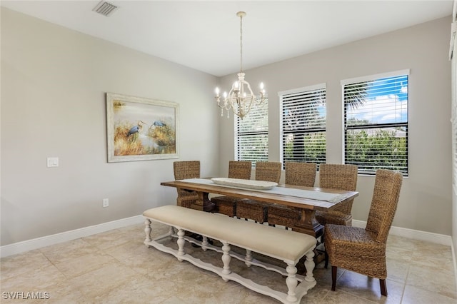 tiled dining room with a notable chandelier