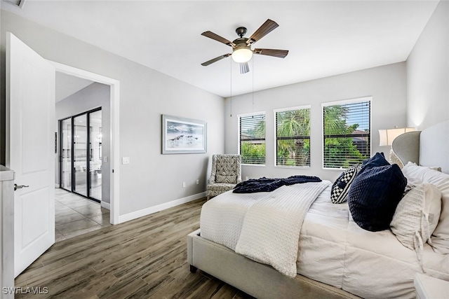 bedroom featuring access to outside, ceiling fan, and hardwood / wood-style flooring