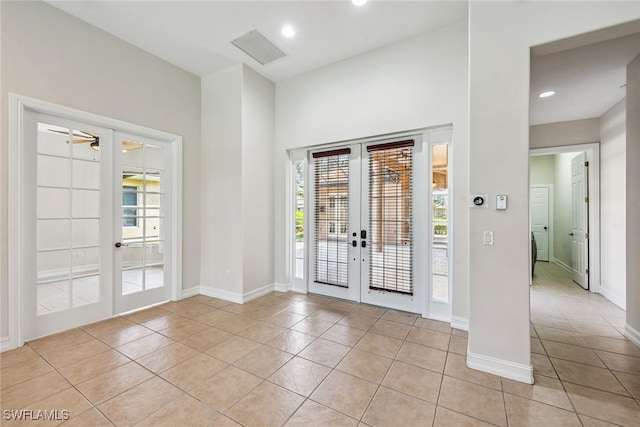 doorway featuring light tile patterned floors and french doors