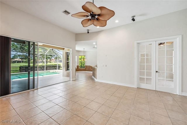 spare room featuring light tile patterned floors, visible vents, french doors, and a sunroom