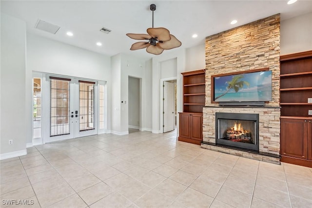 unfurnished living room featuring a fireplace, light tile patterned floors, french doors, and visible vents