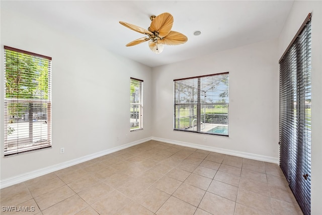 unfurnished room with light tile patterned flooring and ceiling fan