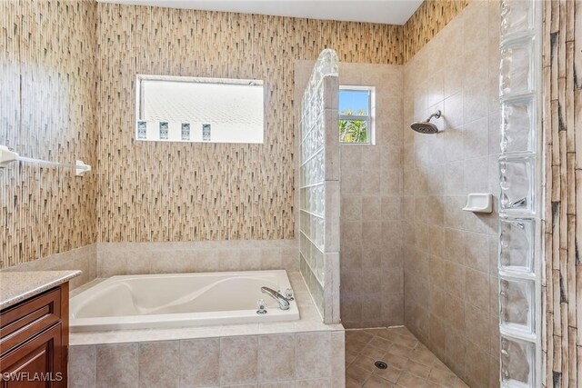 bathroom featuring shower with separate bathtub and vanity