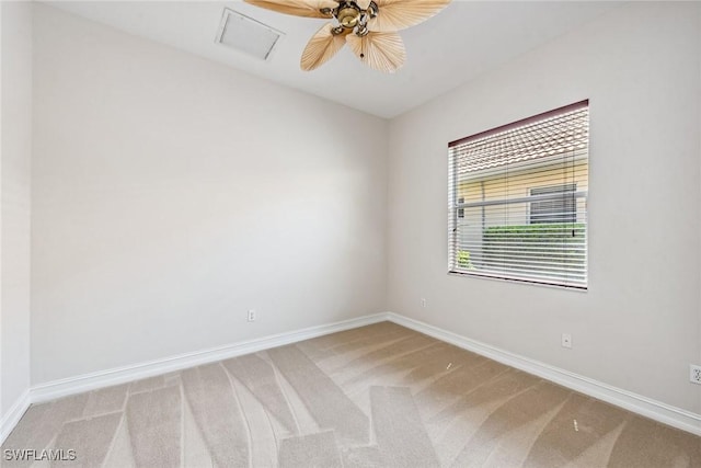 unfurnished room featuring baseboards, light colored carpet, and ceiling fan