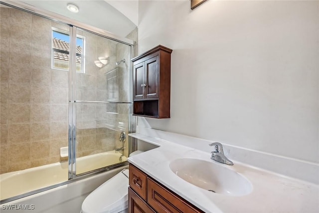 full bathroom with enclosed tub / shower combo, toilet, and vanity