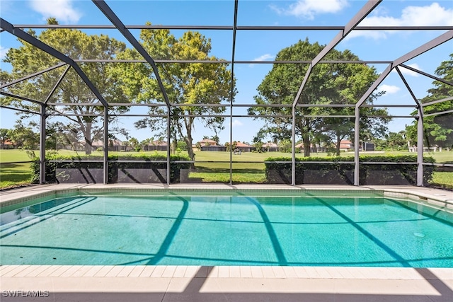 view of swimming pool featuring glass enclosure