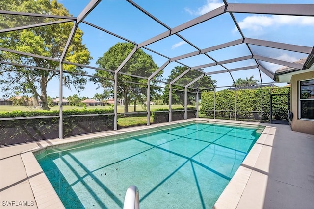 outdoor pool with a lanai and a patio area