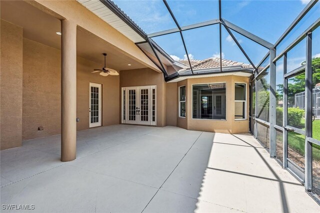 unfurnished sunroom with ceiling fan and french doors