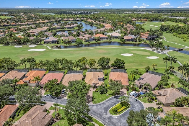 drone / aerial view featuring a residential view, golf course view, and a water view