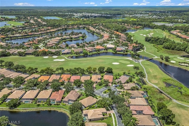 aerial view with golf course view, a water view, and a residential view