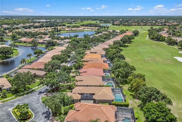 drone / aerial view with a residential view, a water view, and golf course view