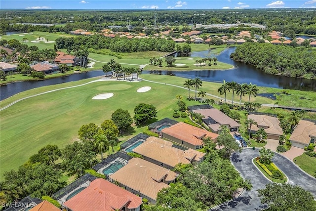 birds eye view of property with a residential view, a water view, and view of golf course