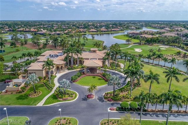 drone / aerial view featuring golf course view and a water view