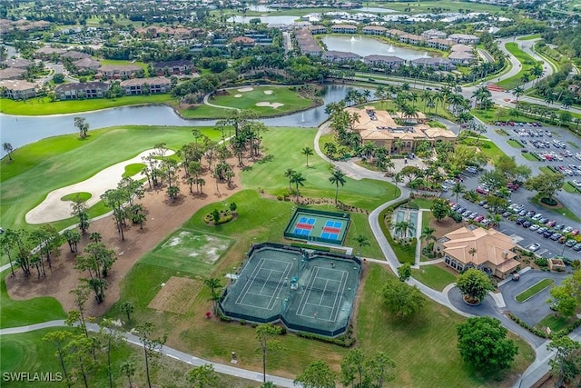 birds eye view of property with a water view and view of golf course