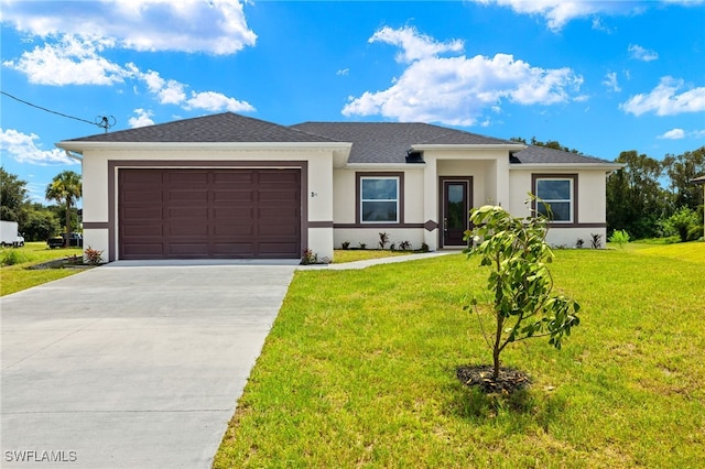 view of front of house with a front yard and a garage