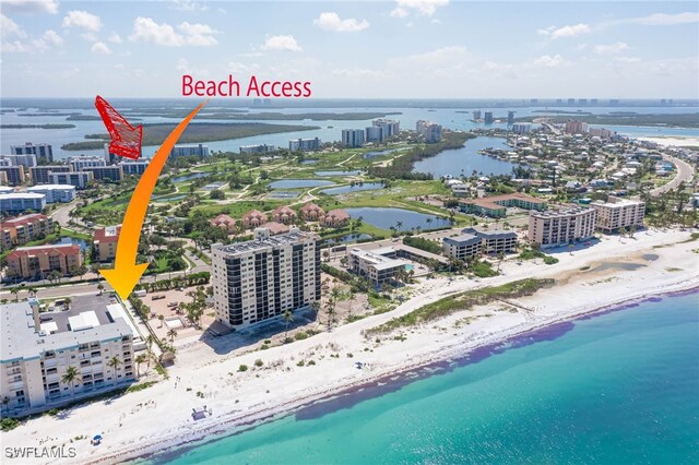 drone / aerial view with a water view and a view of the beach