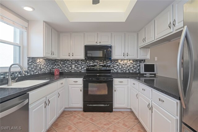 kitchen with black appliances, sink, backsplash, and white cabinetry