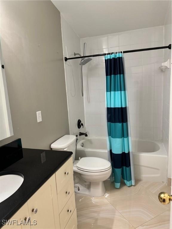 full bathroom featuring shower / bath combination with curtain, vanity, and toilet