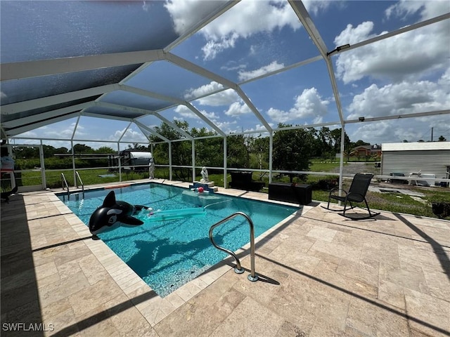 view of pool featuring glass enclosure and a patio area