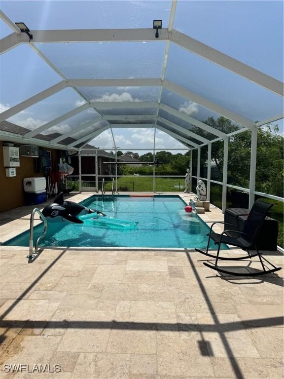 view of pool featuring a lanai and a patio area