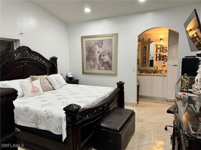 bedroom with sink and ensuite bath