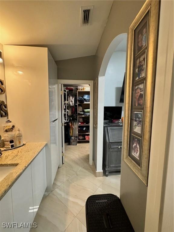 hallway with vaulted ceiling