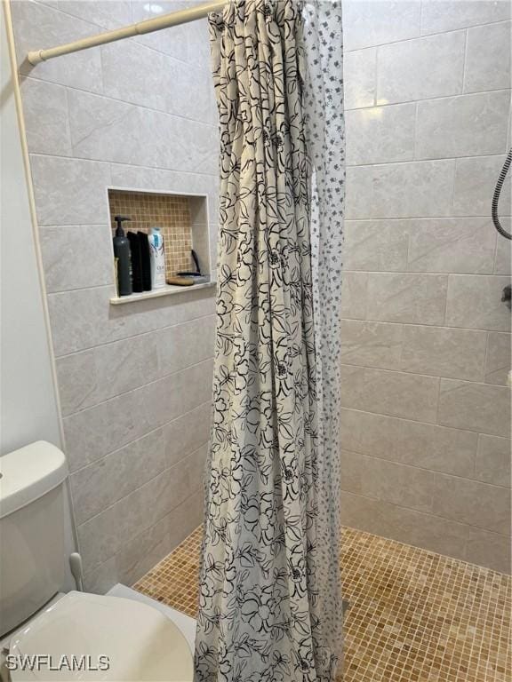 bathroom with walk in shower and toilet