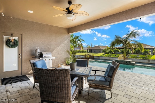 view of patio featuring an outdoor pool, a ceiling fan, and area for grilling