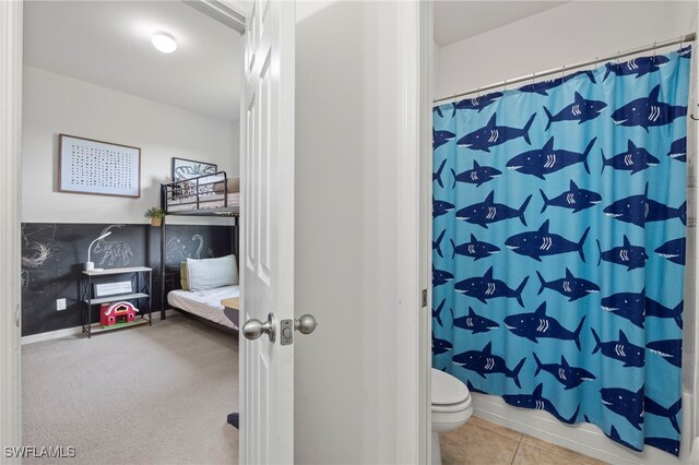 full bathroom featuring curtained shower, toilet, and tile patterned floors