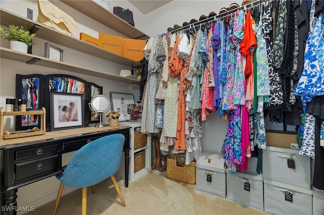 walk in closet with carpet floors and built in study area