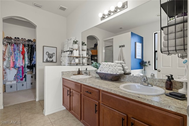 bathroom with tile patterned flooring, a sink, and visible vents