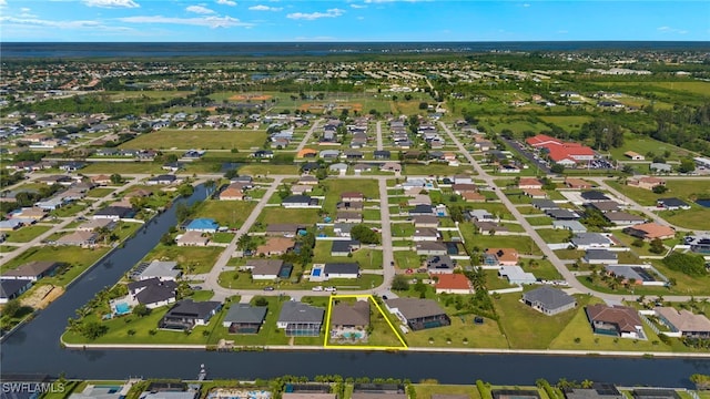 bird's eye view with a residential view and a water view