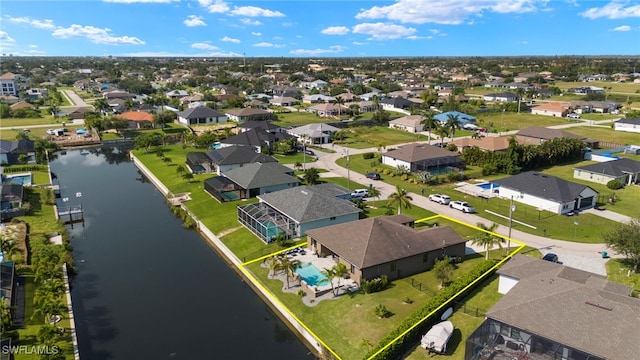 birds eye view of property featuring a water view and a residential view