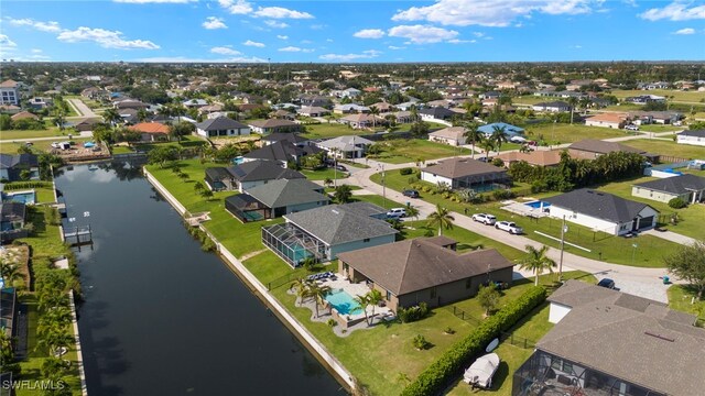 bird's eye view featuring a water view and a residential view