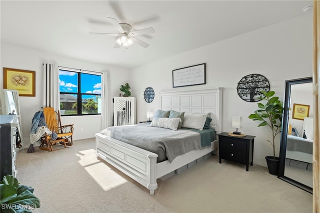 bedroom featuring a ceiling fan and light colored carpet