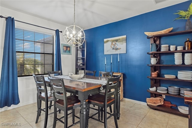 dining area with baseboards, tile patterned flooring, and an inviting chandelier