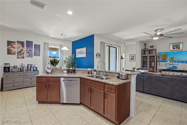 kitchen with light stone counters, a sink, visible vents, open floor plan, and dishwasher