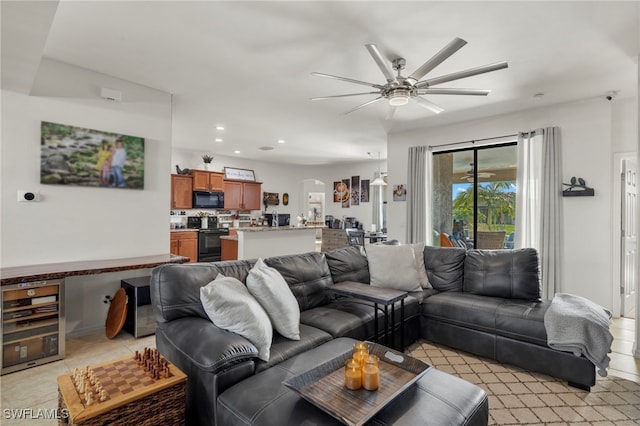 living area with ceiling fan, arched walkways, and recessed lighting