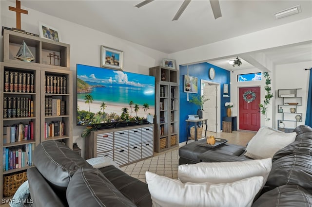 living room featuring a ceiling fan, tile patterned flooring, and visible vents