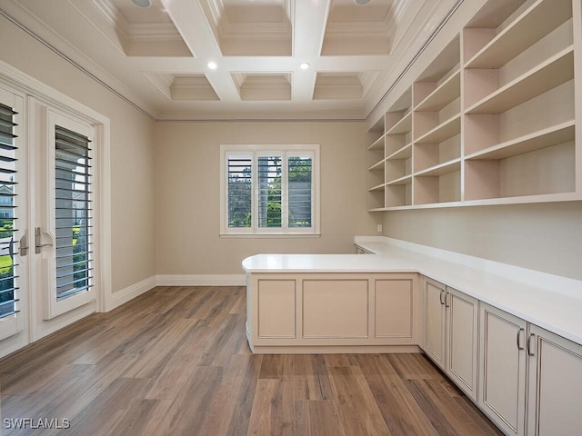 unfurnished office with crown molding, beamed ceiling, coffered ceiling, and light wood-type flooring