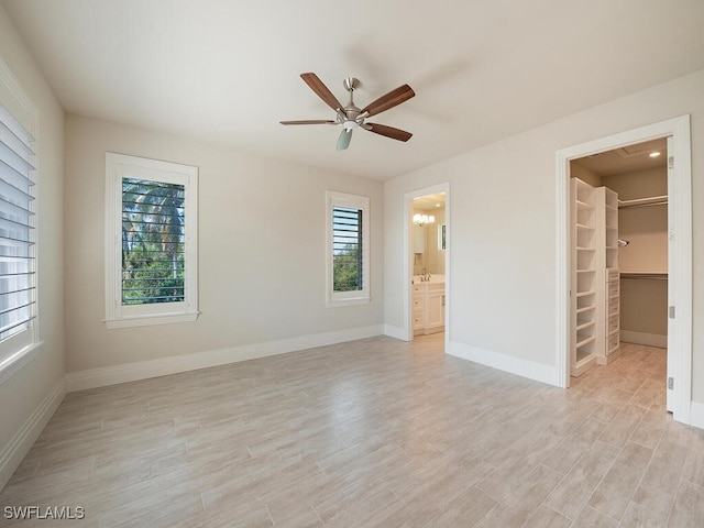 unfurnished room with ceiling fan, plenty of natural light, and light wood-type flooring