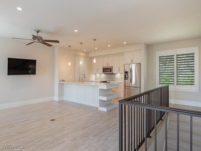 interior space featuring ceiling fan, sink, and hardwood / wood-style floors